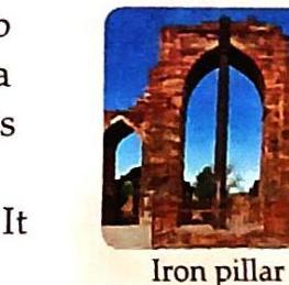 An arched stone ruin frames a view of blue sky and trees, with a dark vertical pillar visible within the archway. The label below reads 'Iron pillar'.
