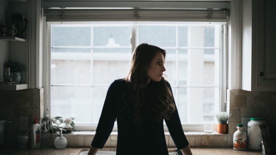 woman sitting on kitchen counter