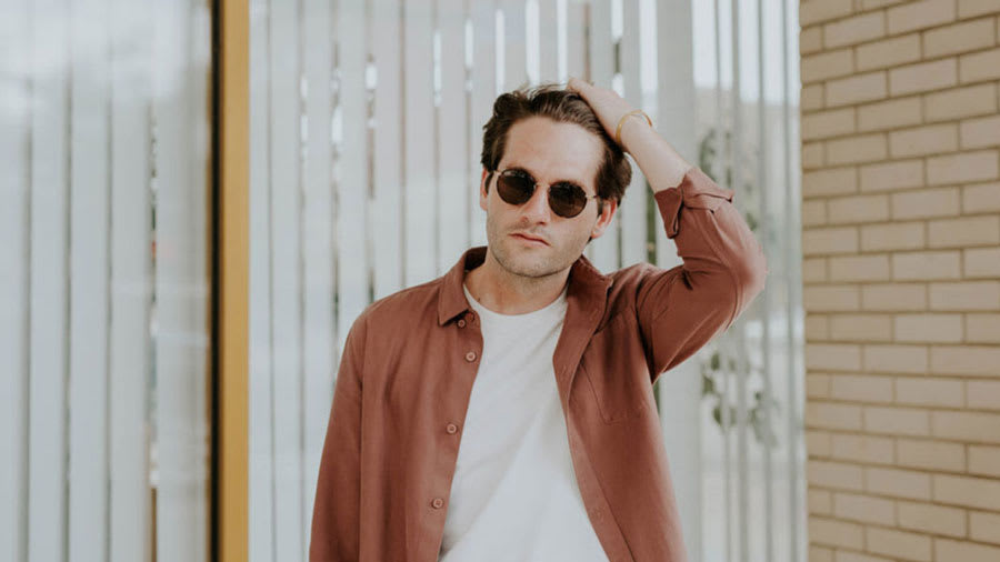 man wearing sunglasses scratching scalp psoriasis