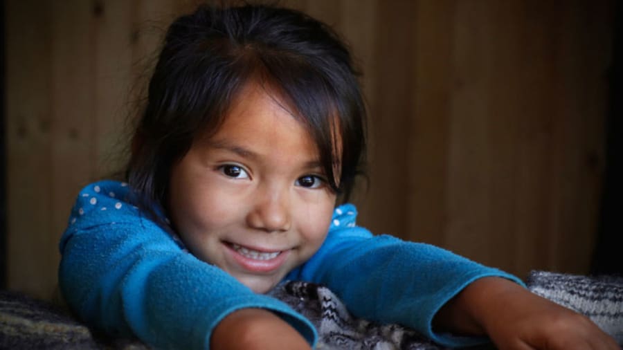 Girl smiling with blue shirt and no eczema
