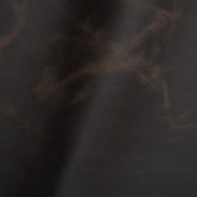 Vintage leather pull-up effect Close-up of coal vintage leather showing the pull-up effect, with lighter tones where oils and waxes shift under stress