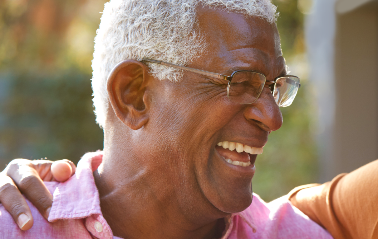grey haired man laughing