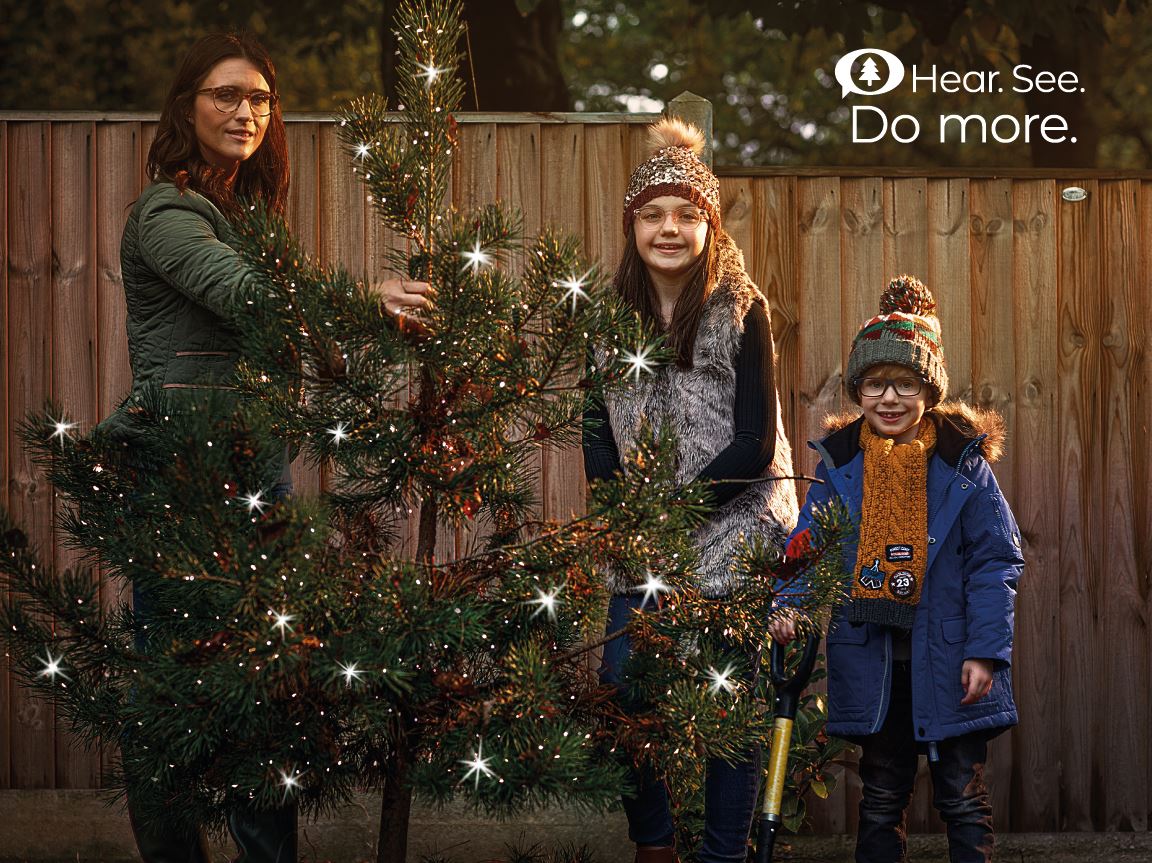 family planting a tree in winter