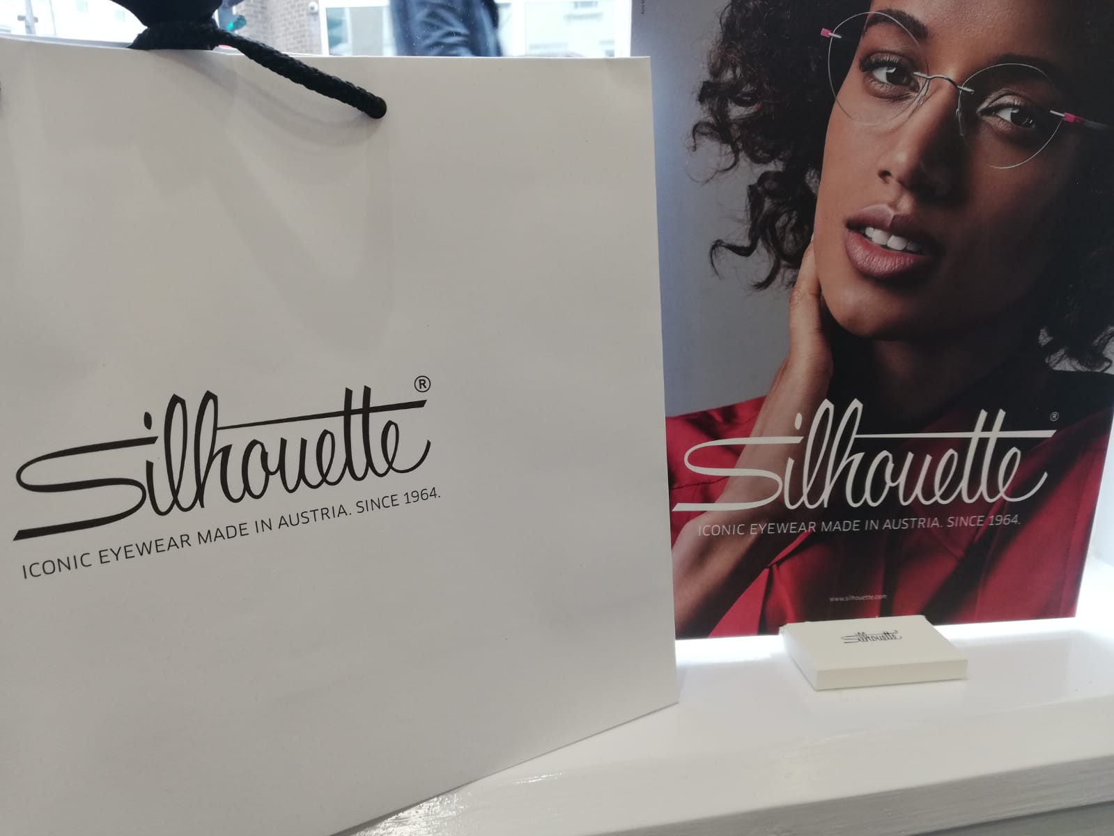 A Silhouette bag next to a Silhouette campaign poster.