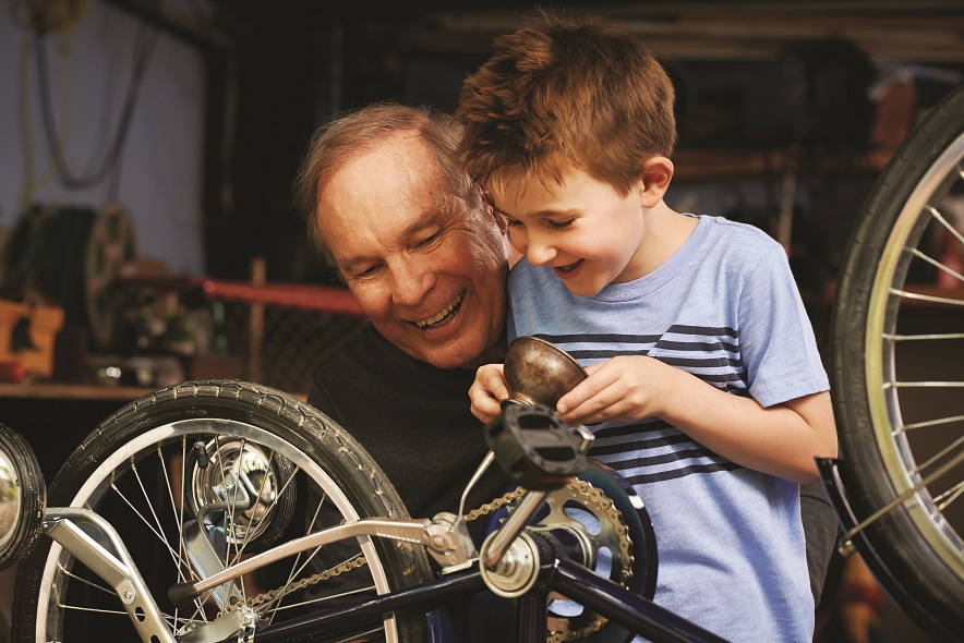 grandfather and child fixing bicycle