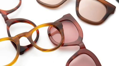 Display of acetate frames, featuring several styles without arms and others without lenses, showcasing a variety of colours.