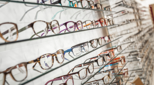 Shelves filled with a diverse selection of glasses, showcasing various styles, colors, and designs for eyewear enthusiasts.