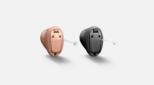 Oticon Own IIC style hearing aid, designed for invisibility in the ear, showcasing its discreet and custom fit.
