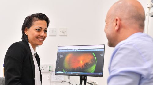 An optometrist with a patient during an appointment.