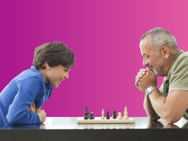 Man and child playing chess