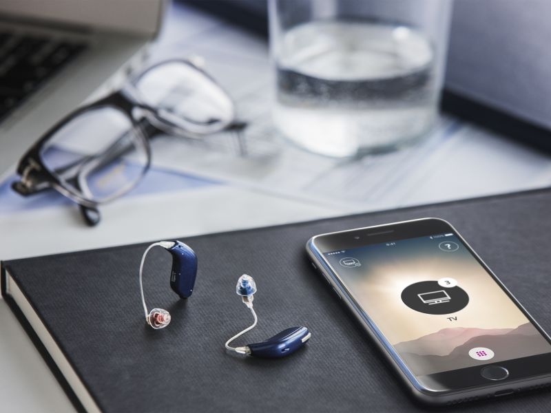 phone and hearing aids on table