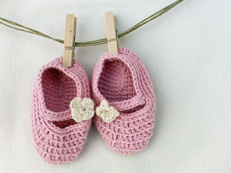 Pair of knitted pink baby shoes