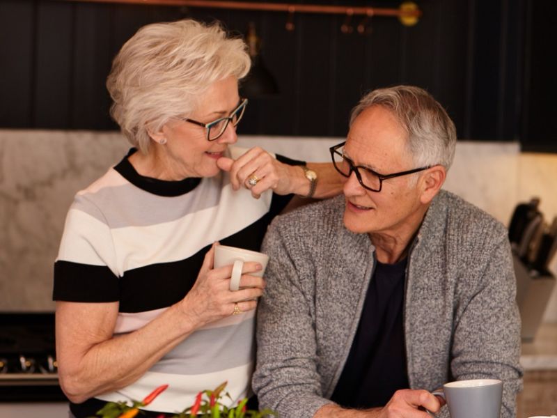 Man and woman drinking tea in kitchen