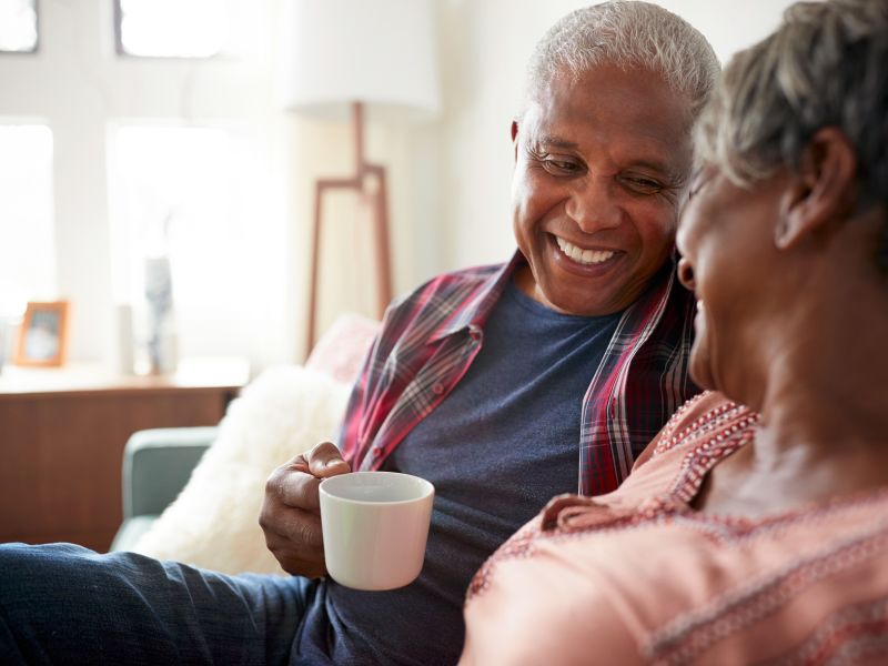 Man and woman drinking tea and laughing