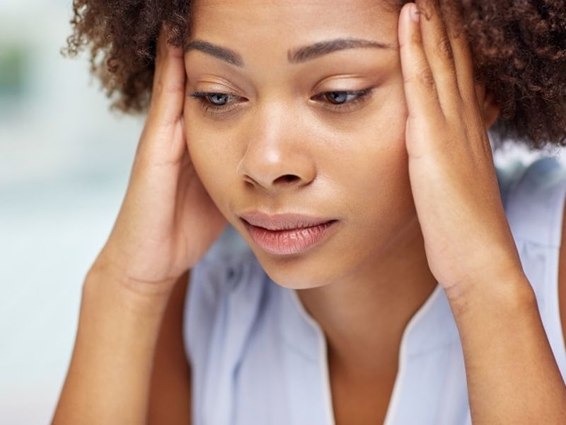 Concerned woman holding sides of head