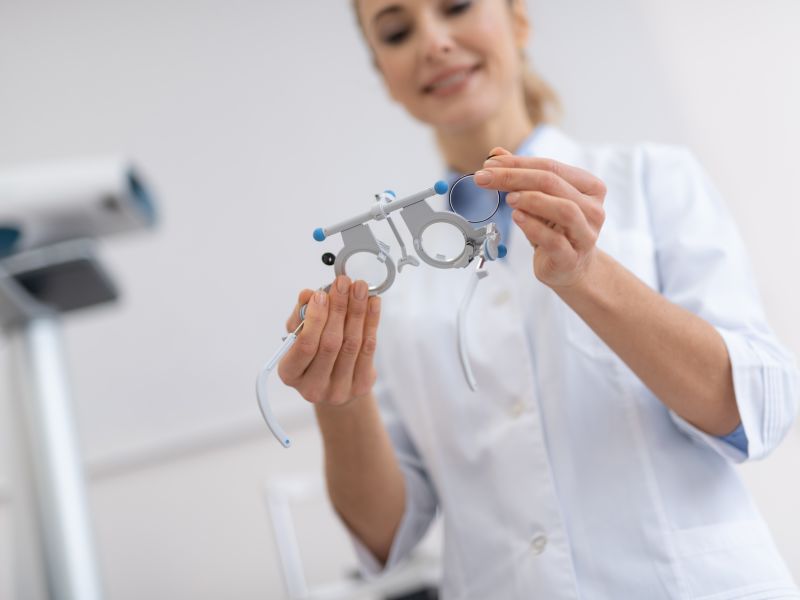 Optometrist inspecting trial frames