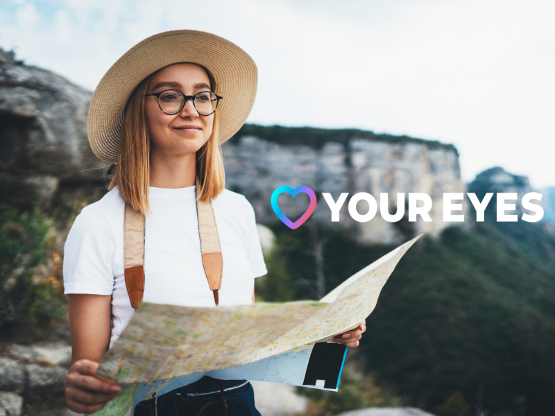 A young woman smiling and looking away with a map.