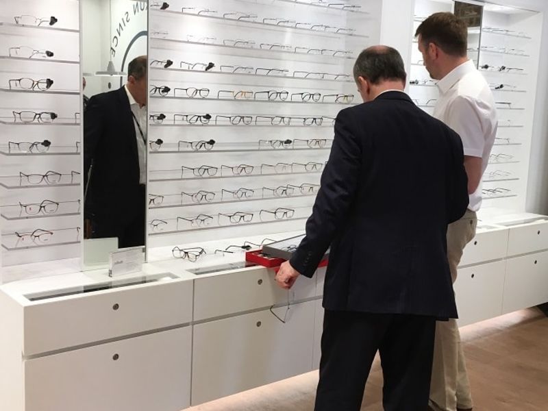 Two men checking out glasses