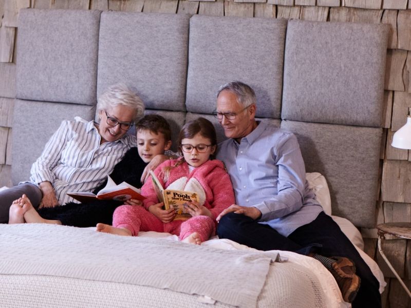 Family in bed reading books