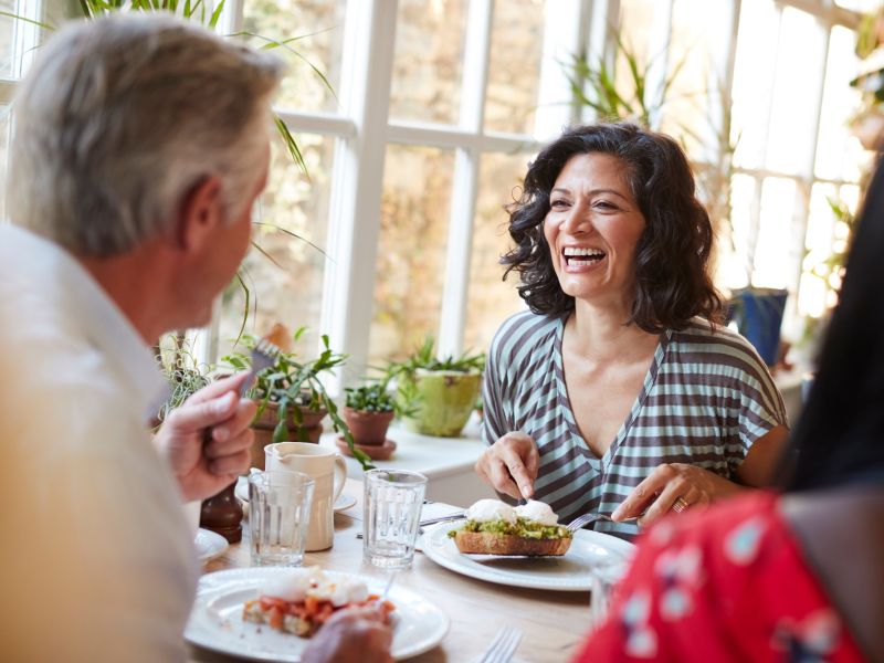 hearing aid wearer laughing at lunch