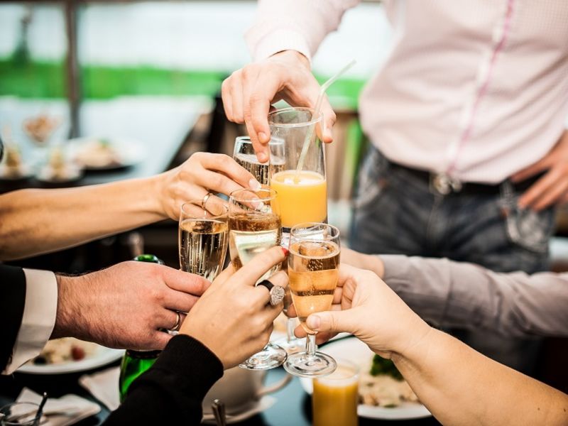 Group of people clinking prosecco glasses