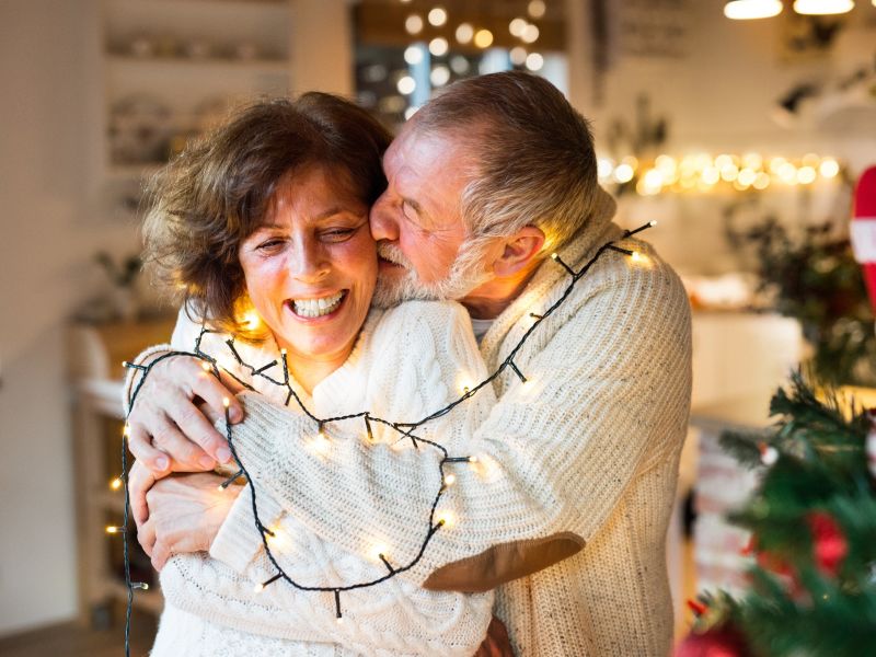 husband and wife laughing away the holiday blues