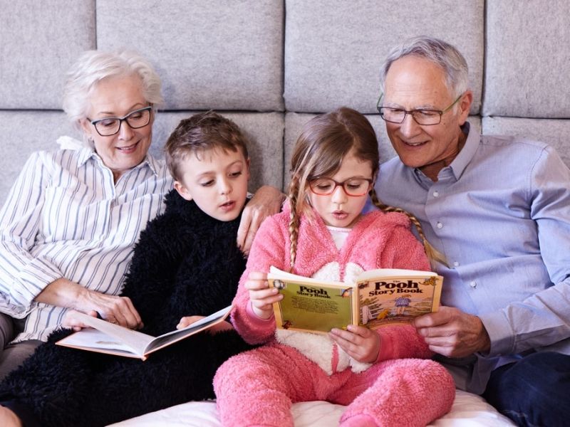 Family in bed reading books