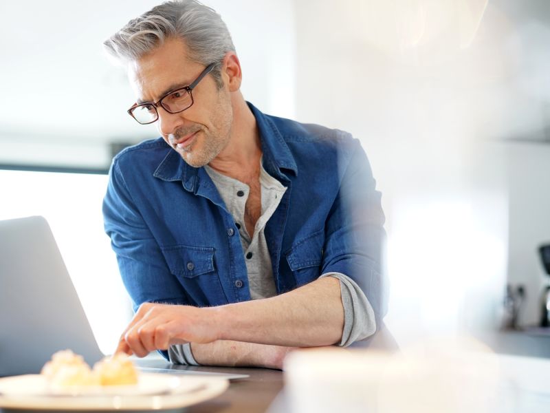 Man using laptop wearing glasses