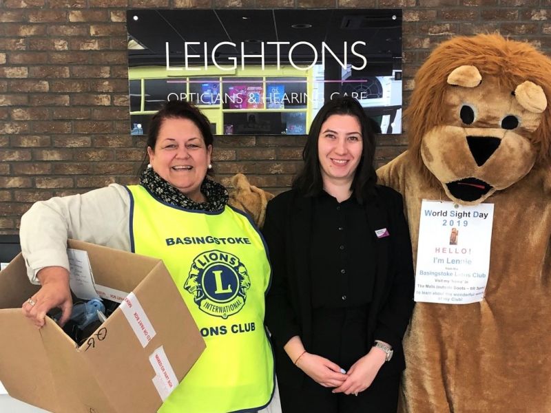 A Leightons team member between Lion Club international mascot and member.