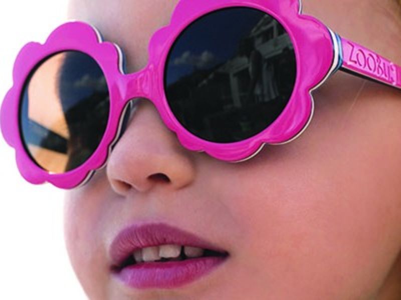 Young girl wearing pink sunglasses