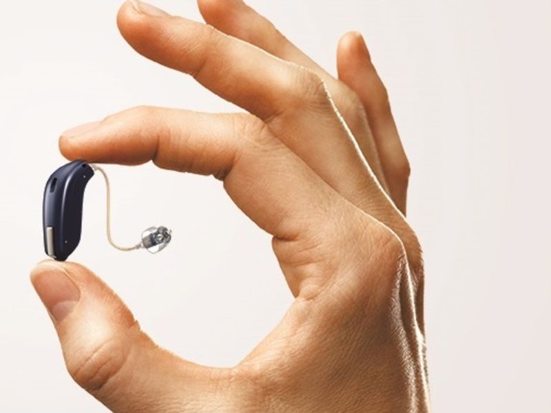 Hand holding hearing aid