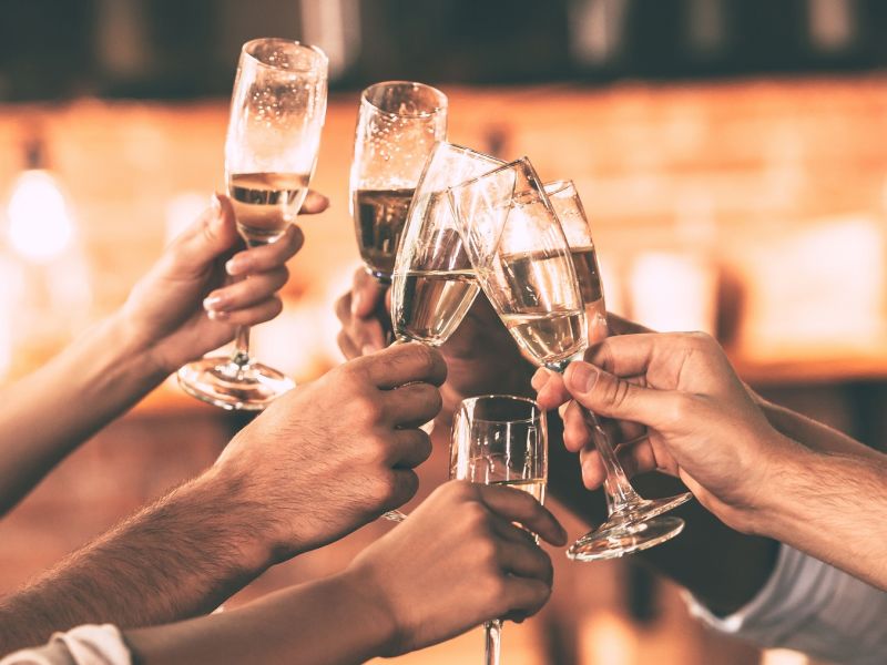 Group of people clinking prosecco glasses