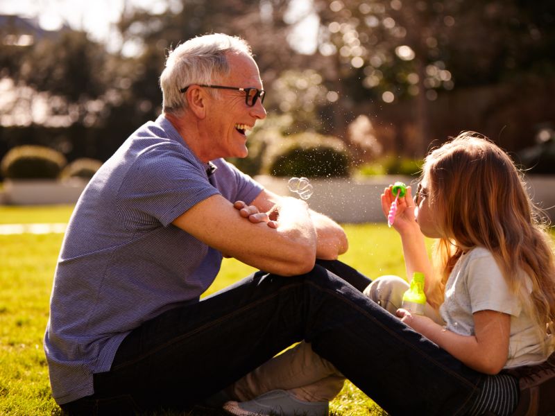 Man and child blowing bubbles