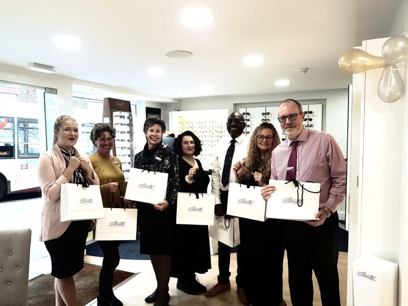 Leightons staff holding Silhouette bags.