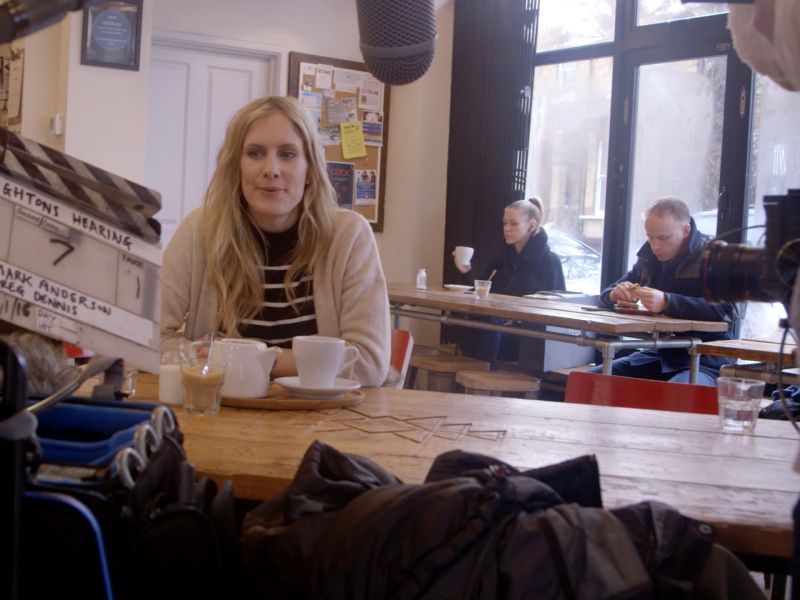 Woman being filmed in a café