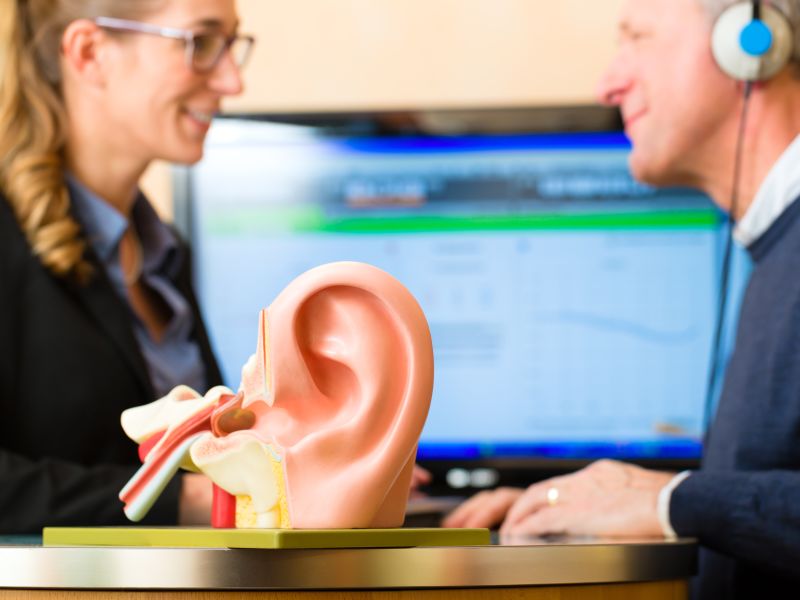 Sample ear and man and woman in background