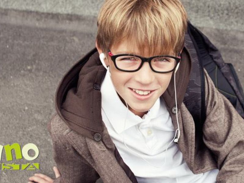 Child sat down wearing glasses and earphones