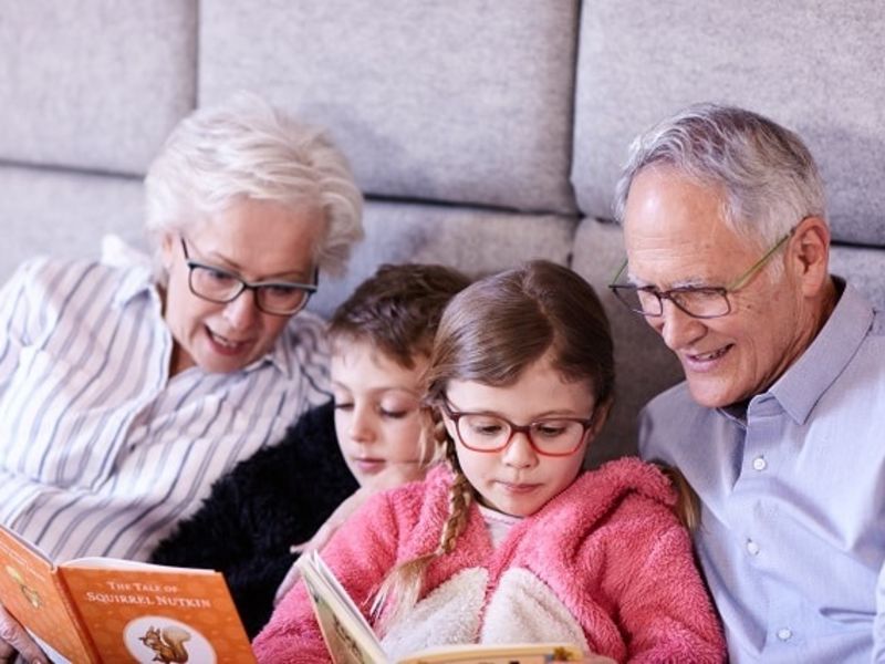 Family in bed reading books