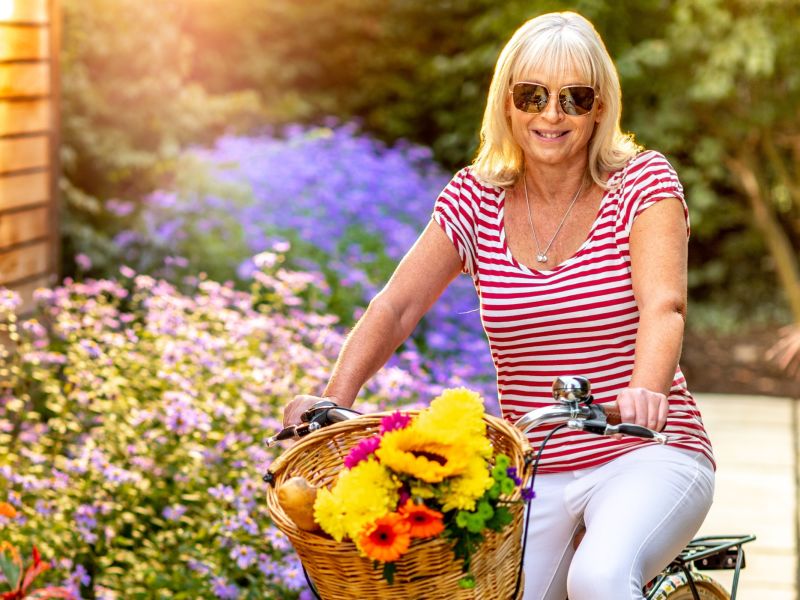 Woman on a bike wearing sunglasses