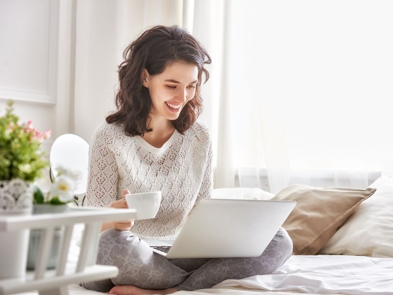 Woman on laptop drinking coffee