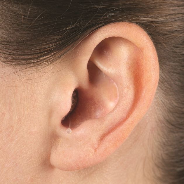 A woman's ear with Invisible-In-Canal Hearing Aids.