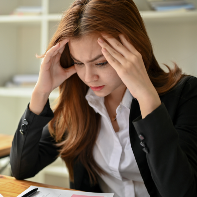 Close-up image of a woman focuses on work struggling to focus.