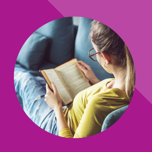 Woman reading a book on the sofa