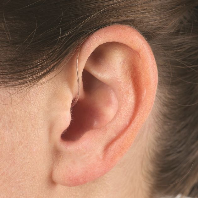 A woman's ear with Receiver-In-Canal Hearing Aids.