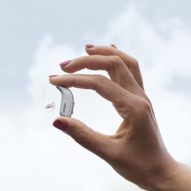 Oticon hearing aid in hand