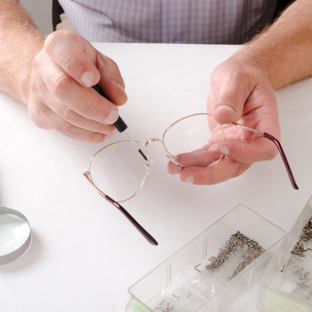 A professional optician adjusting the nose pads on a pair of glasses, ensuring a comfortable fit for the customer.