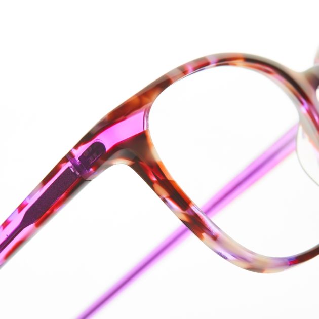 A close up of glasses hinges with a purple frame.