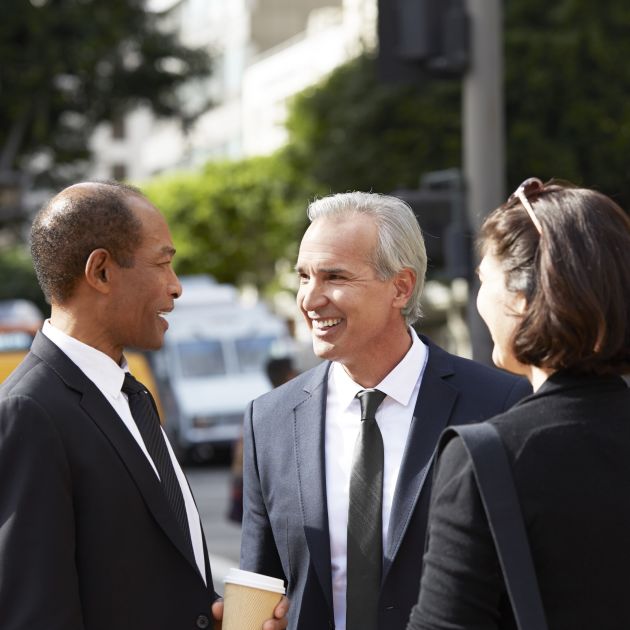 3 people in suits talking