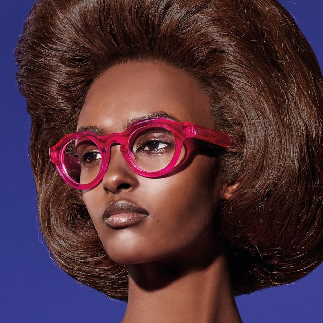 A model wearing pink glasses from the BOLD eyewear collection.