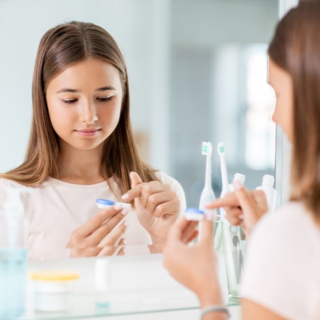 child putting in contact lenses